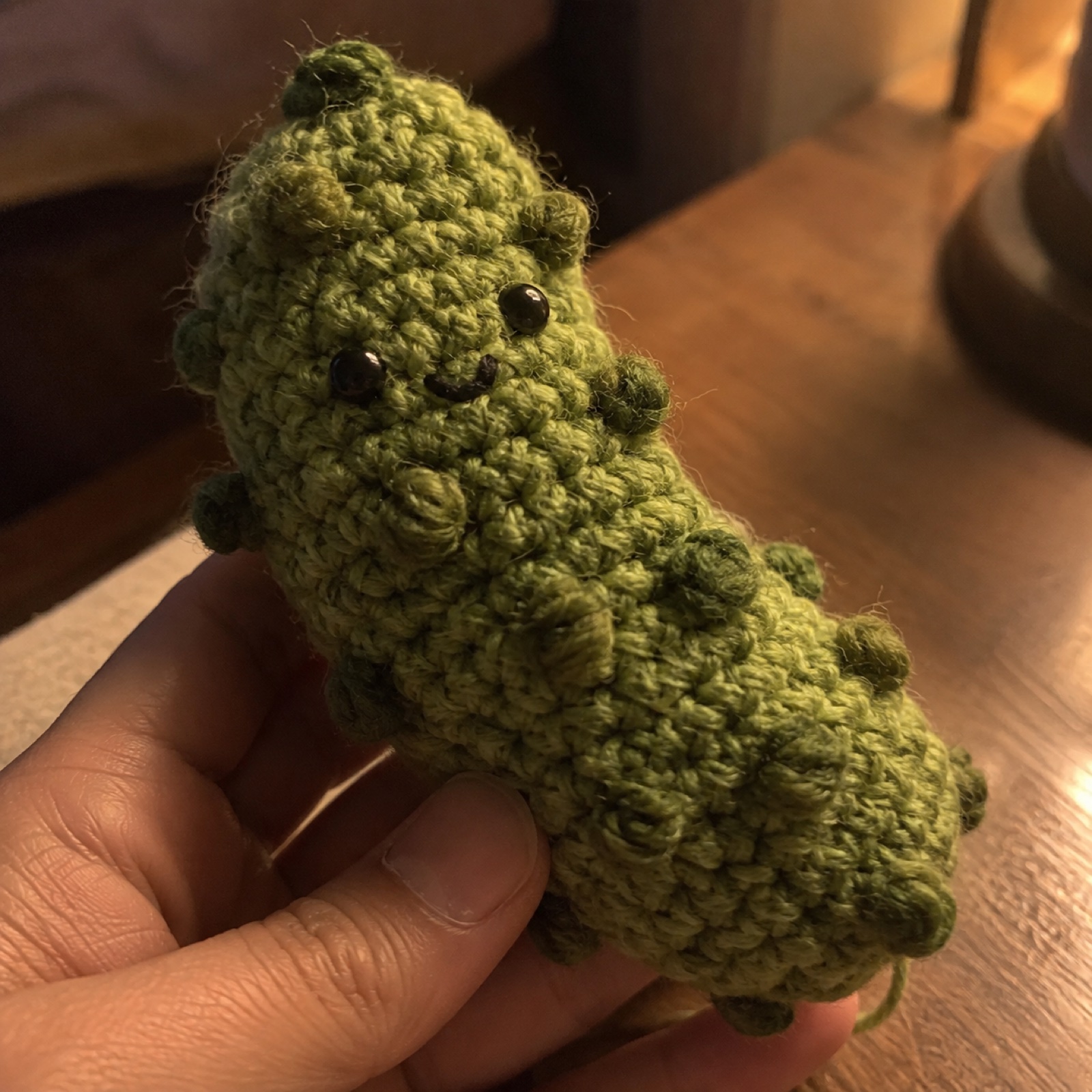 Close-up of the raised bobble-stitch bumps on the pickle's skin on the Emotional Support Pickle