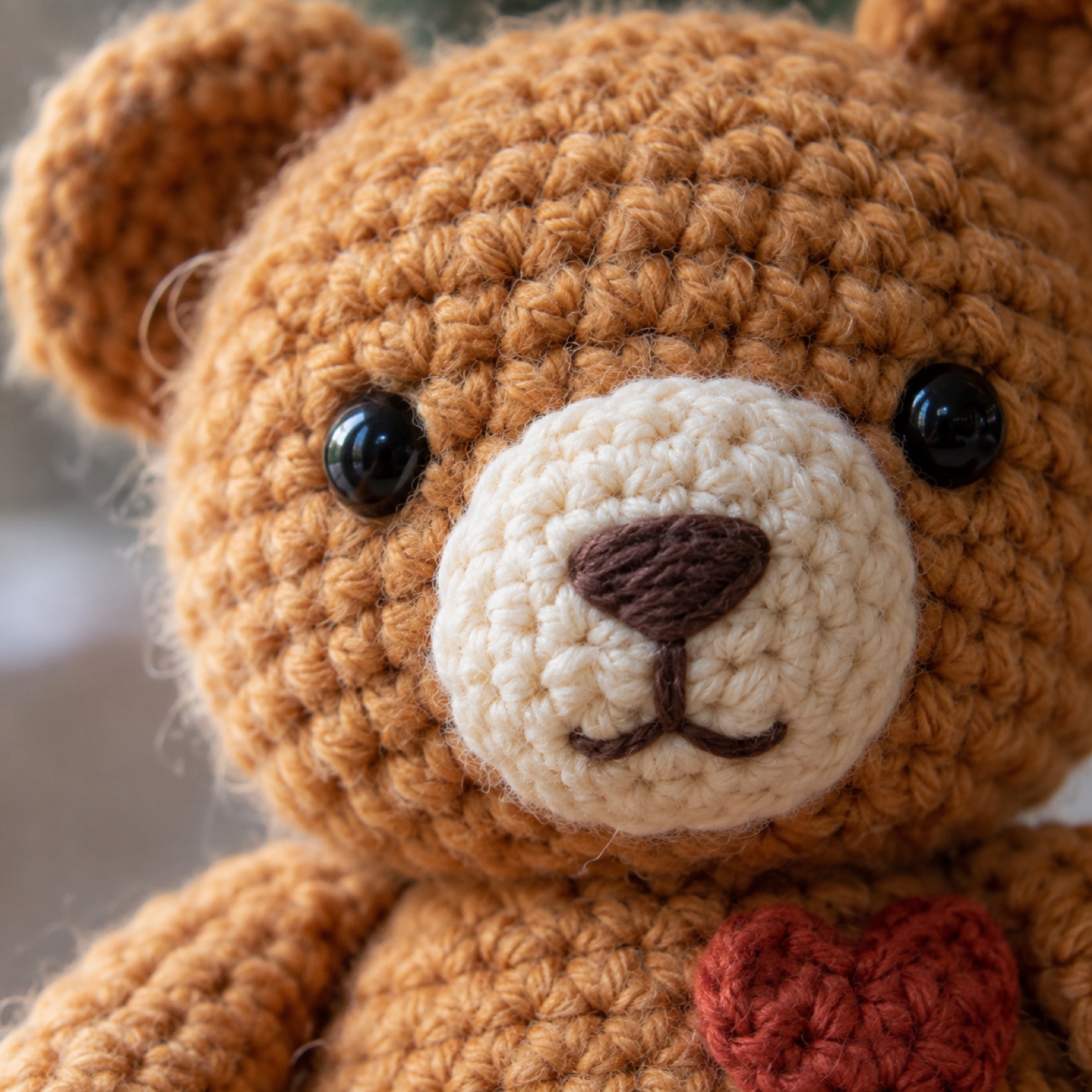 Close-up of the cream muzzle and embroidered cocoa nose on the Honey Bear