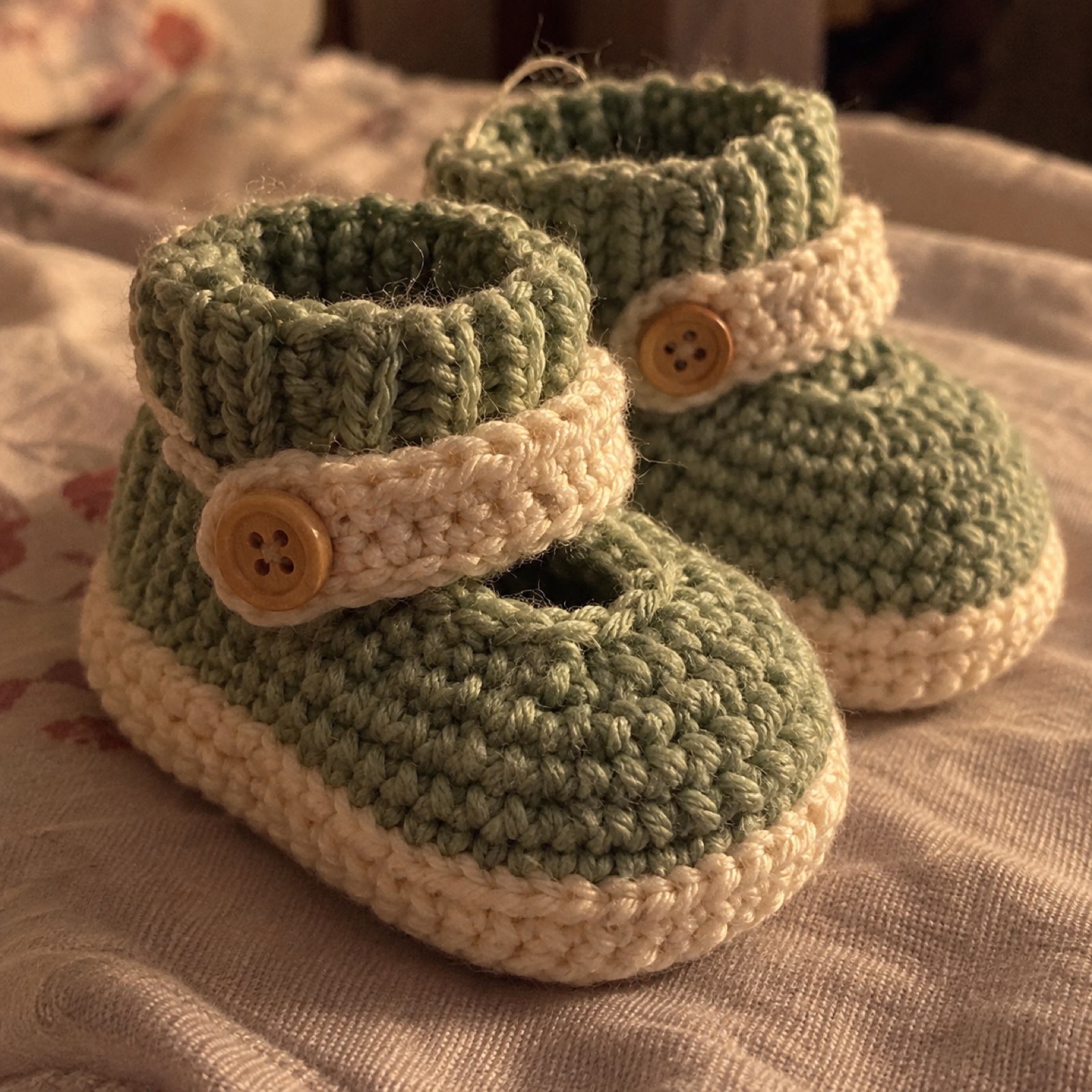 Close-up of the ankle strap and wooden button on the First Steps Booties