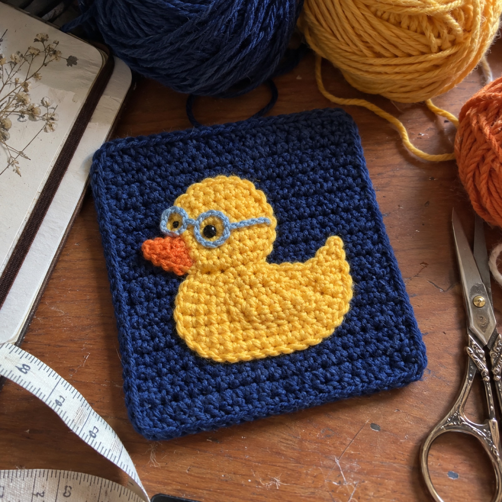 Vibe Debug Duck Coaster: handmade crochet square coaster with a vibe debug duck appliqué