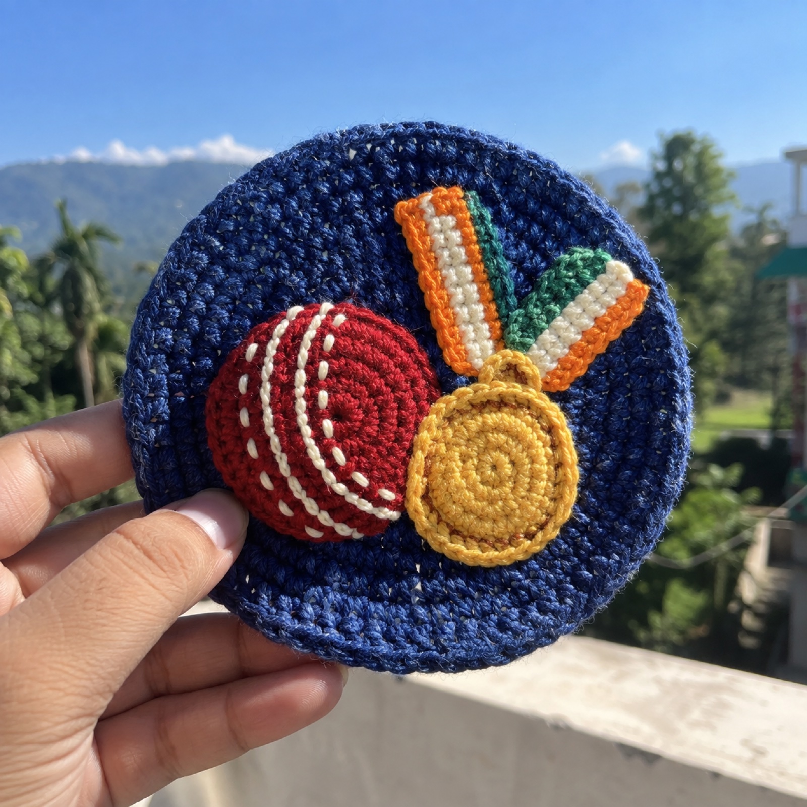 Cricket Gold Coaster: handmade crochet round coaster with a cricket gold appliqué