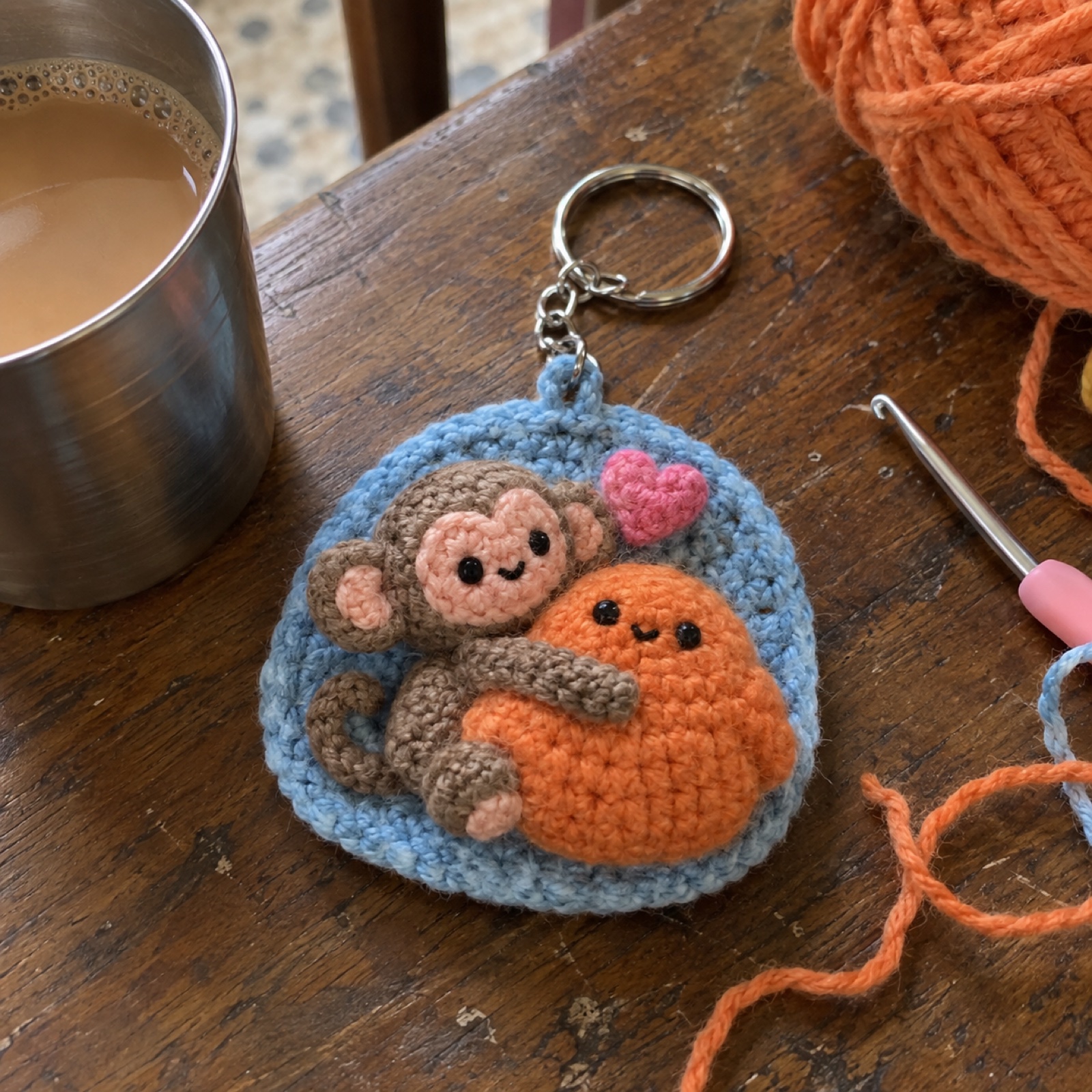 Hang In There Monkey Keychain: handmade crochet keychain / bag charm with a hang-in-there monkey appliqué