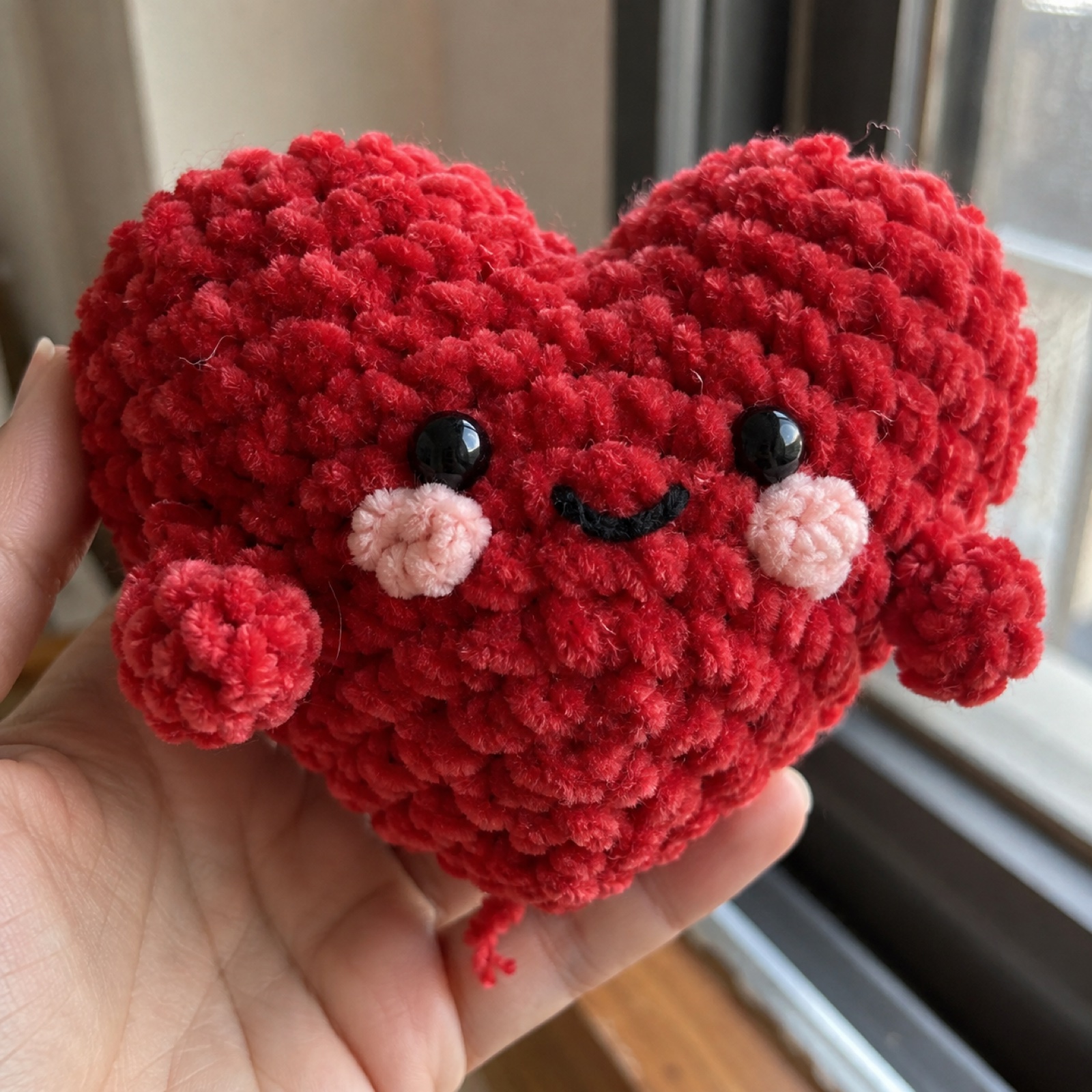 Close-up of the plush chenille texture around the blush cheek on the Valentine Puffy Heart Plush