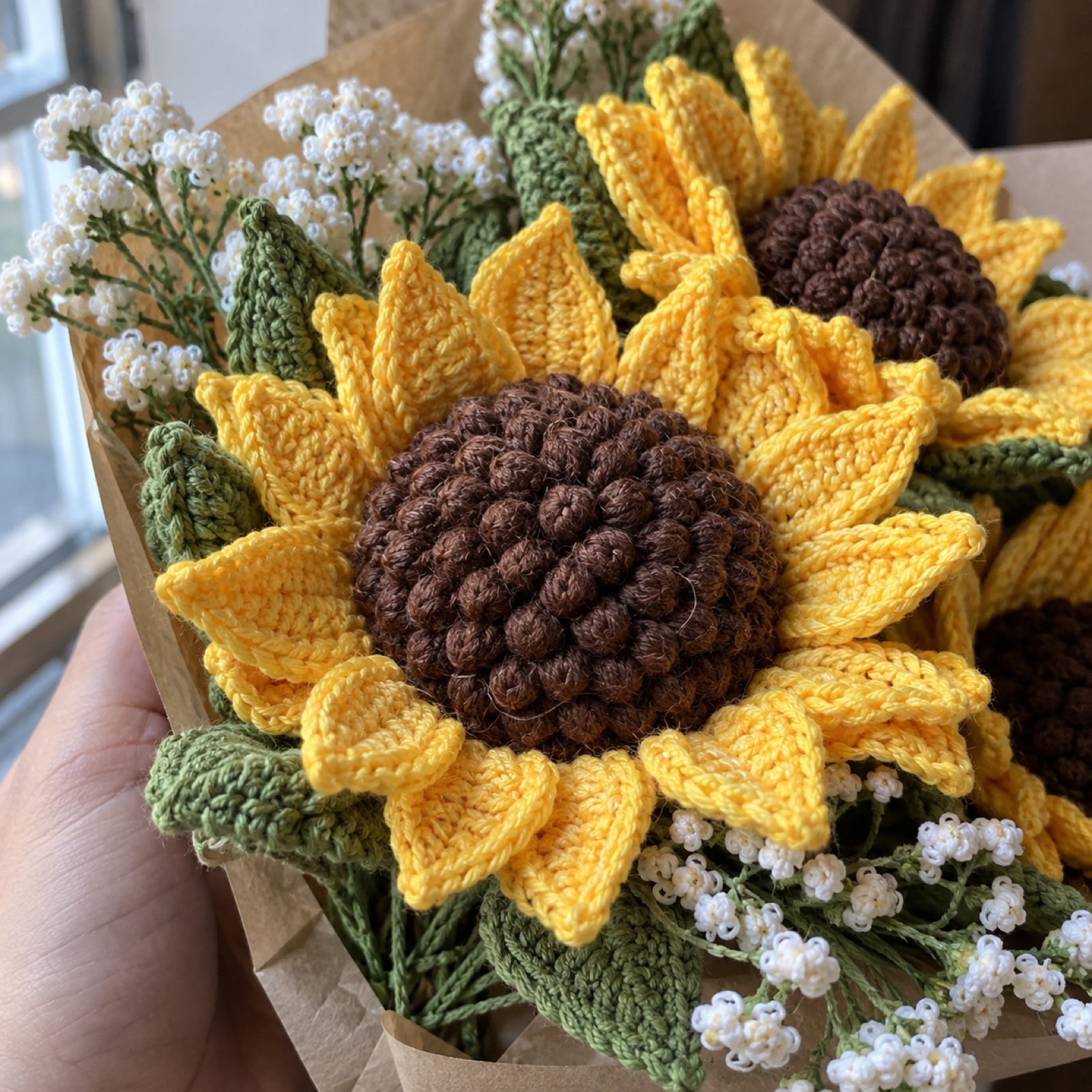 Close-up of the raised bobble-stitch cocoa centre of a sunflower on the Sunflower Sunshine Bouquet