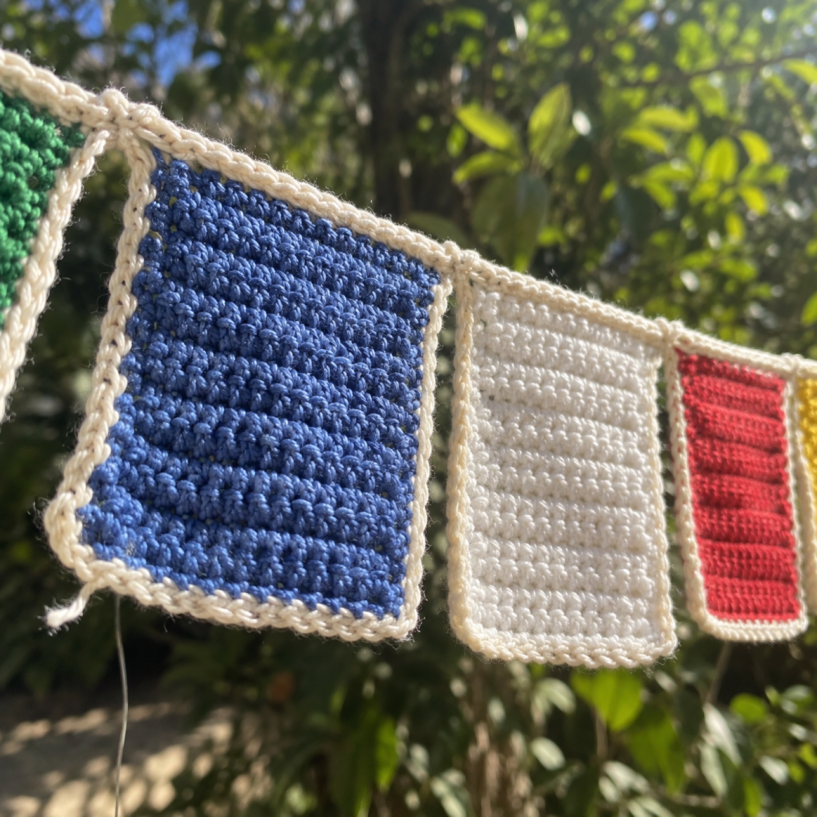 Close-up of two flags and the cord loop they hang from on the Prayer Flag Bunting