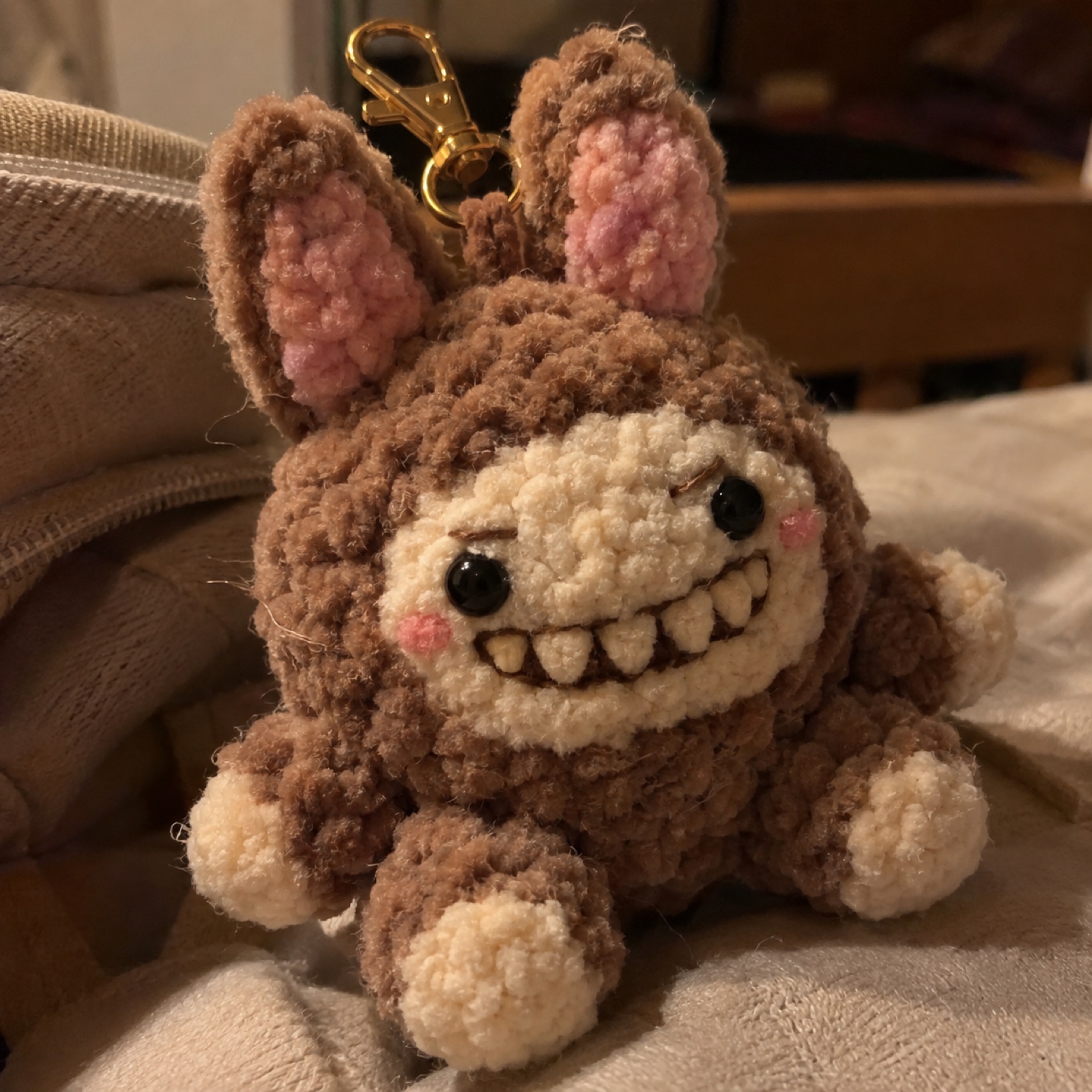 Close-up of the toothy cream grin and fuzzy chenille texture on the Lil Hill Monster Bag Charm