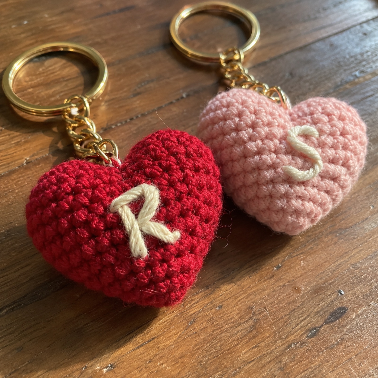 Close-up of the embroidered cream initial on the red heart on the Two Hearts Couple Keychains