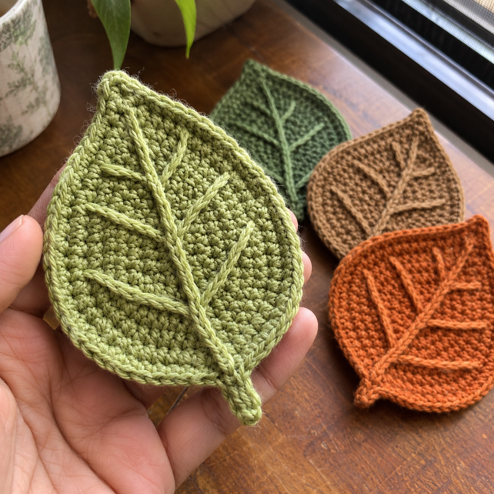 Close-up of the raised surface-crochet midrib and veins on a leaf coaster on the First Flush Teacup Coasters (Set of 4)
