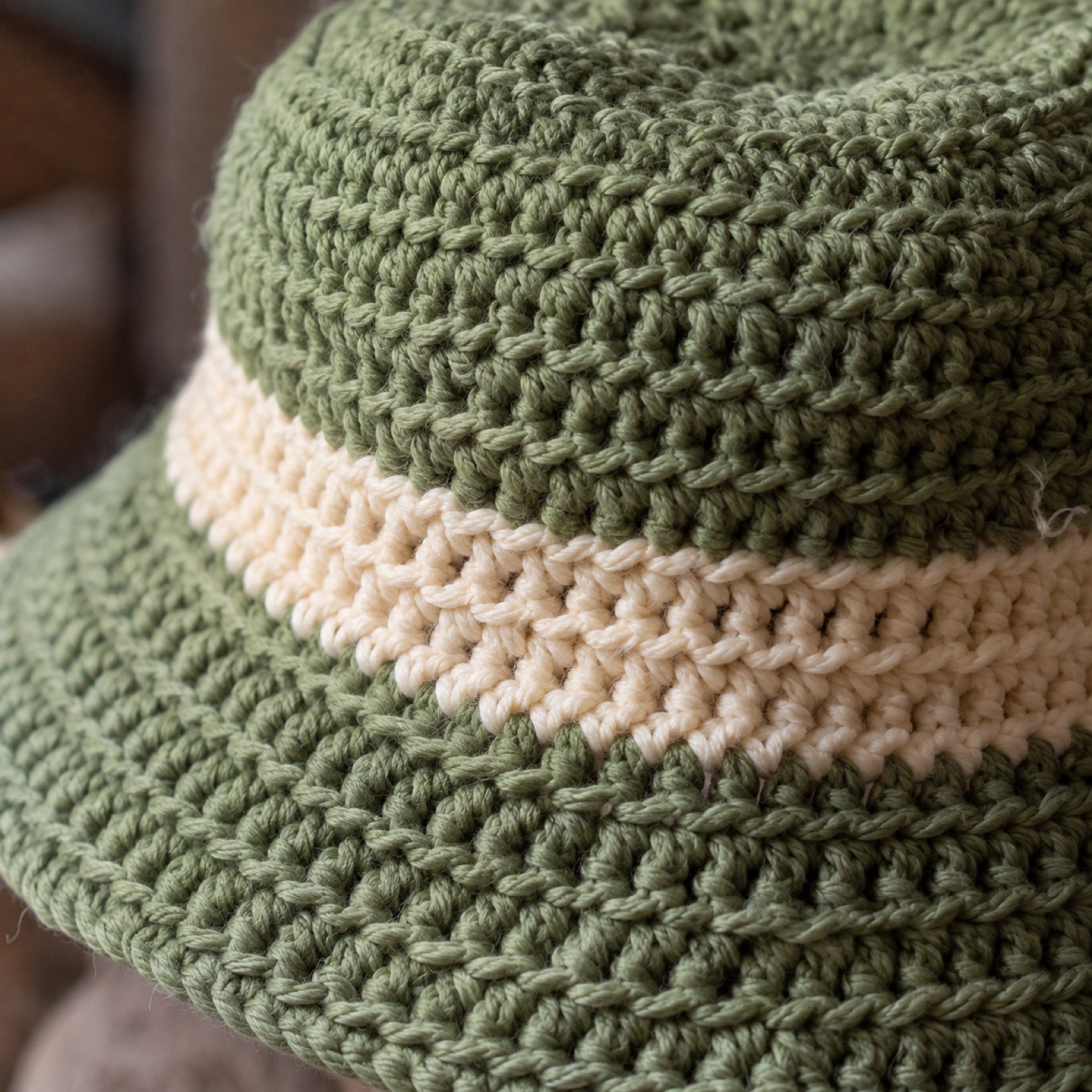 Close-up of the cream band stripe and the brim's increase rounds on the Café Bucket Hat
