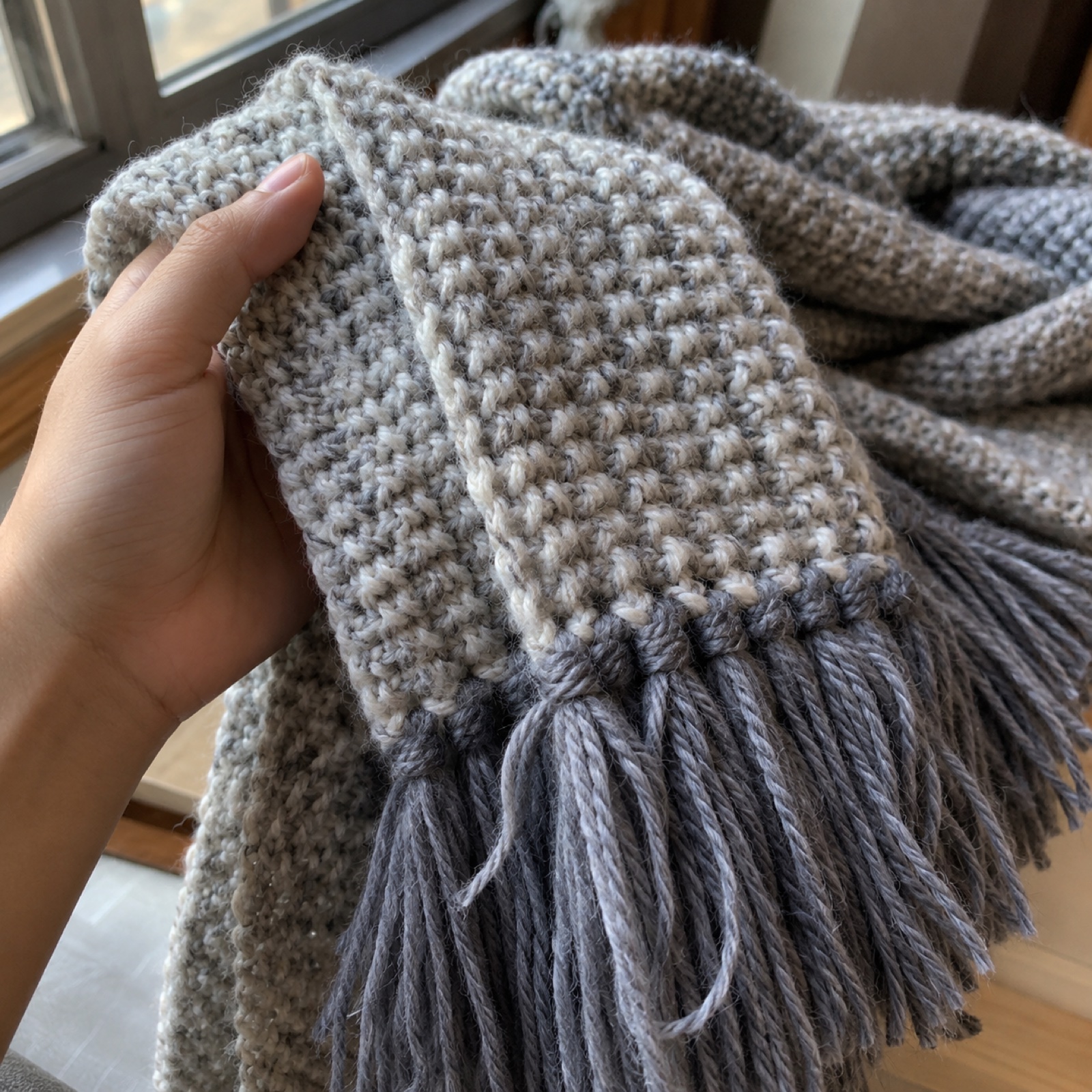 Close-up of the fringe knots and moss-stitch texture on the Misty Morning Ribbed Scarf